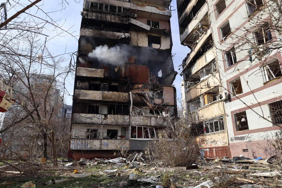 Emergency personnel work at the scene following a drone attack in the town of Rzhyshchiv, Kyiv region