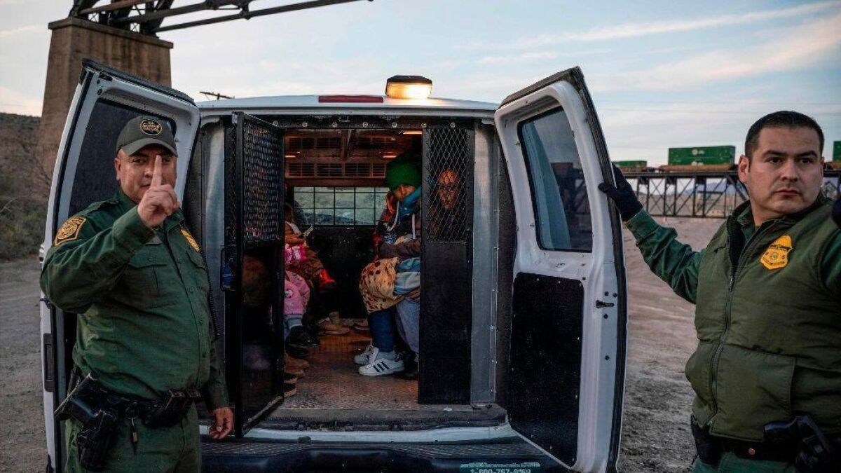 A group of Brazilian migrants take their seats in a U.S. Border Patrol van after crossing the border from Mexico.