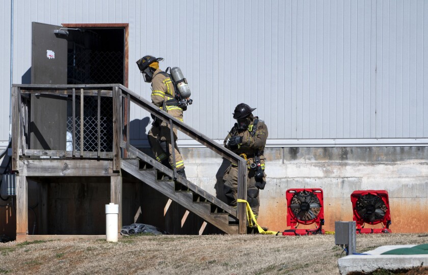 Two Hall County Firefighters enter a back door Friday, Jan. 29, 2021, at Foundation Food Group in Gainesville, Ga., the day after six people were killed following a liquid nitrogen leak at the plant. (Scott Rogers/The Times via AP)