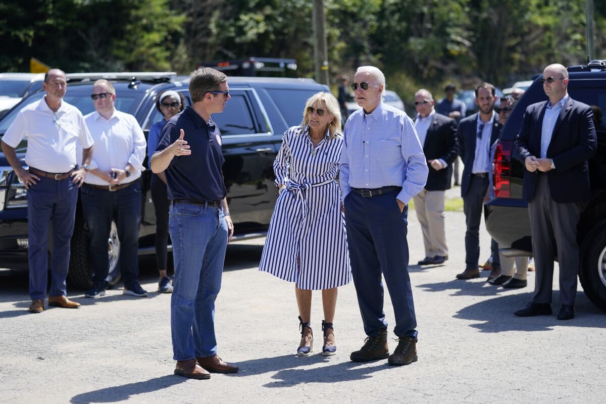 FILE - President Joe Biden and first lady Jill Biden talk with Kentucky Gov. Andy Beshear while they view flood damage in Lost Creek, Ky., Aug. 8, 2022. Beshear complained Thursday, Aug. 11, 2022, that the Federal Emergency Management Agency is denying too many requests for assistance in flood-ravaged eastern Kentucky, and urged those getting turned down to take their cases directly to agency representatives in the region. (AP Photo/Evan Vucci, File)