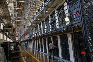 Narrow prison cells are stacked five stories high on San Quentin's death row.
