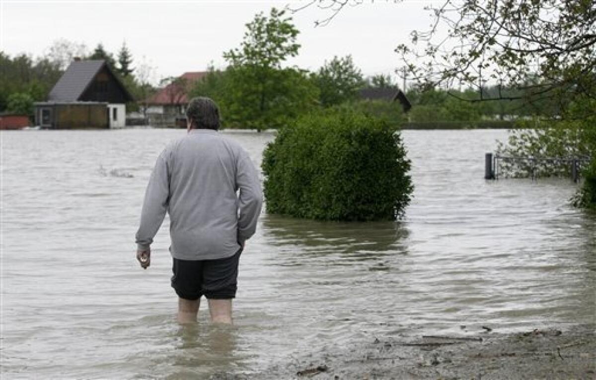 A resident walks through flooded street of Bohumin, north east Czech Republic, Tuesday, May 18, 2010. Floods, caused by days of heavy rain, swept through central Europe on Monday and Tuesday, killing at least four people and forcing the evacuation of thousands more. (AP Photo/Petr David Josek)
