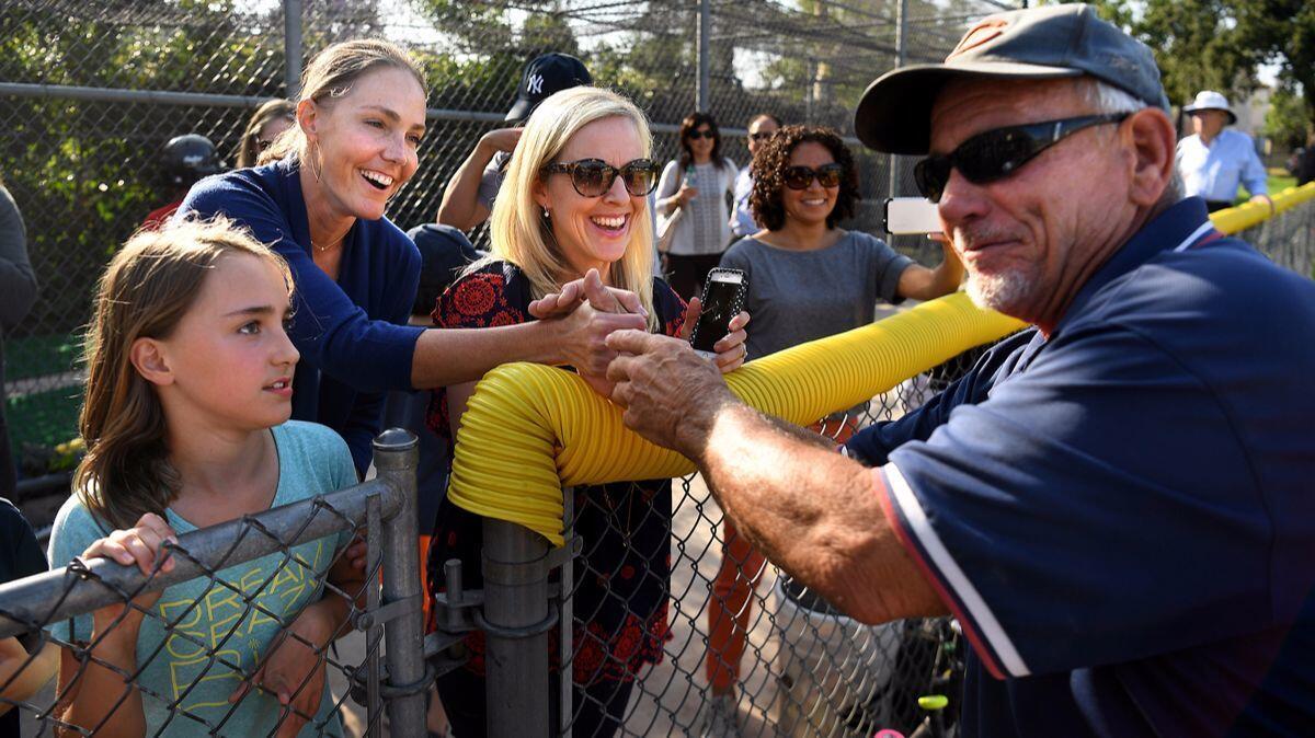 Umpire Pete Constantino shakes hands with parents after a Southwest Pasadena little league game. Constantino has been an umpire for 40 years.