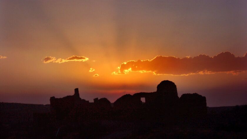 The setting sun highlights the ruin of Pueblo del Arroyo in the archeologically rich Chaco Canyon in New Mexico.