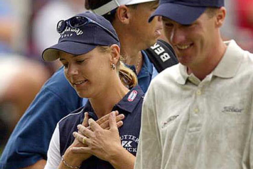 Annika Sorenstam walks off the 13th green with playing partner Aaron Barber, right, and her caddie Terry McNamara after making a birdie at the Colonial Country Club in Fort Worth, Texas. Sorenstam became the first woman to compete in a PGA Tour event in 58 years.