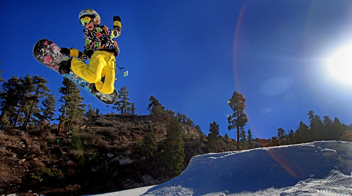 A snowboarder soars high off a jump at Bear Mountain, Big Bear Lake. Mammoth Mountain ski resort's purchase of Bear Mountain and Snow Summit in Southern California creates a new season pass that goes on sale Saturday.