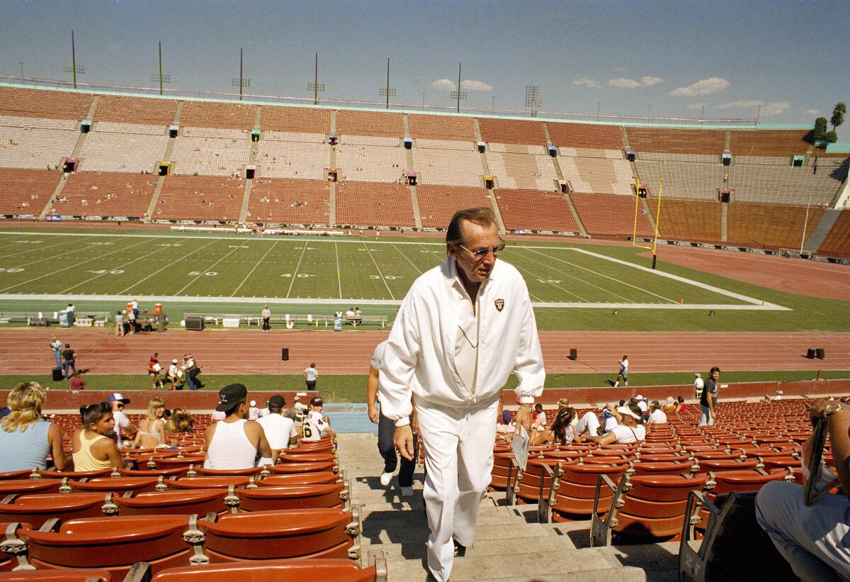 Raiders owner Al Davis climbs the steps at the Coliseum before a game between the Raiders and Chiefs on Oct. 4, 1987.