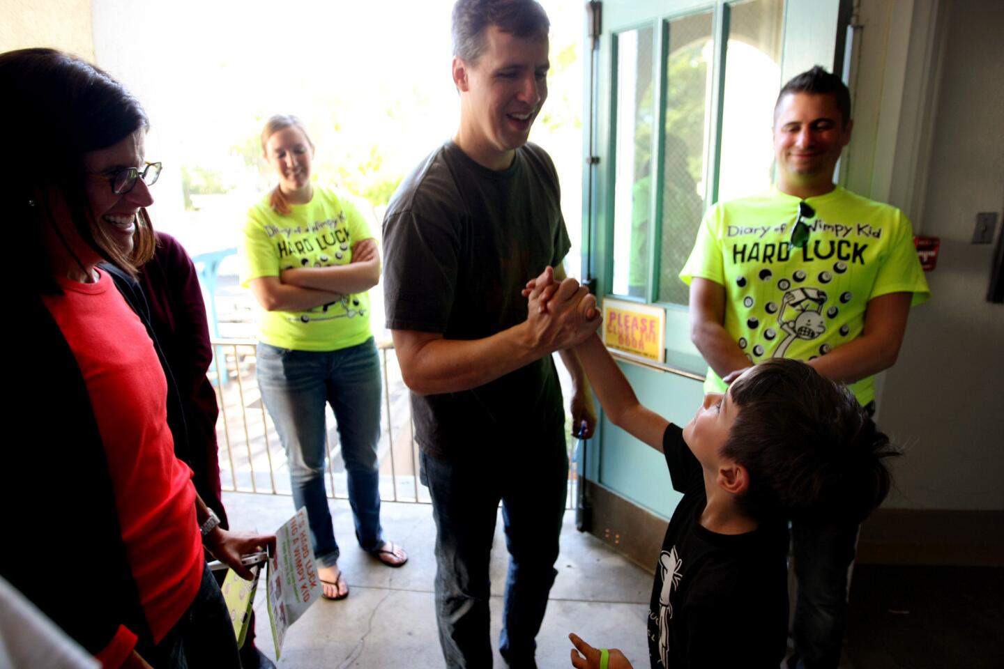 "Diary of a Wimpy Kid" writer Jeff Kinney greets a student at Franklin Avenue Elementary School in L.A. Kinney is on a bus tour promoting the latest entry in his series, "Diary of a Wimpy Kid: Hard Luck."