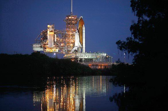 The space shuttle Discovery is prepared for launch in Cape Canaveral, Fla., after two earlier attempts were scrubbed. The launch of the shuttle to the International Space Station has been rescheduled for Friday morning .