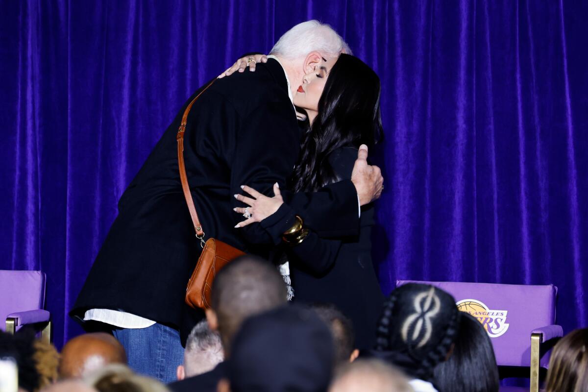 Vanessa Bryant hugs former Lakers coach Phil Jackson during a Kobe Bryant statue unveiling ceremony outside Crypto.com Arena.