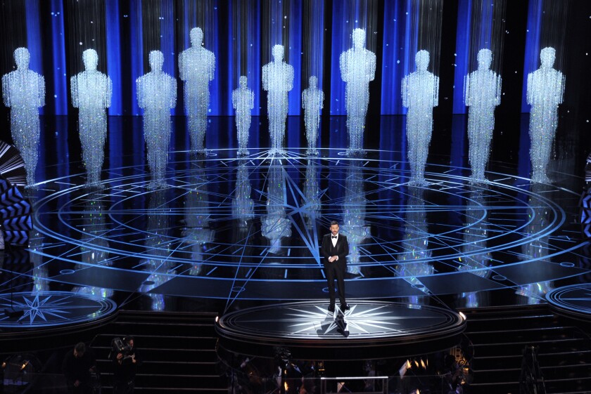 FILE - In this Feb. 26, 2017 file photo, host Jimmy Kimmel speaks at the Oscars in Los Angeles. Some people watch awards shows out of love, others because they love to hate. But this year, as ratings have taken a dive, will anybody tune in to the Oscars? Pushed by the pandemic from its usual berth of February or early March, the Academy Awards will be presented April 25 on ABC. (Photo by Chris Pizzello/Invision/AP, File)