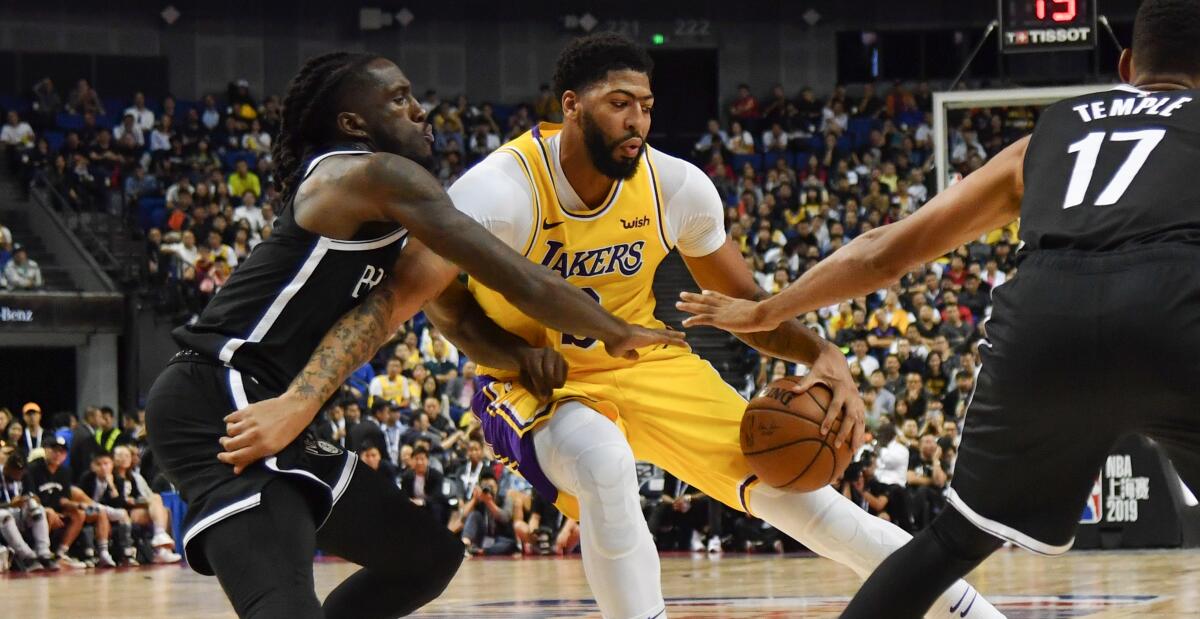 Lakers forward Anthony Davis looks to score against Nets forward Taurean Prince during the game Thursday night in Shanghai.