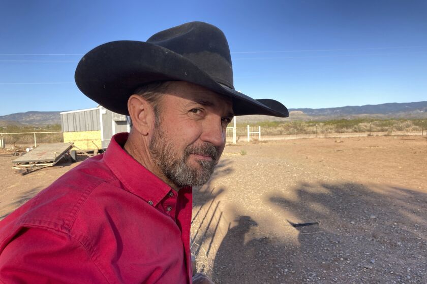 FILE - In this May 12, 2021, file photo, Otero County Commissioner Couy Griffin, the founder of Cowboys for Trump, takes in the view from his ranch in Tularosa, N.M. In a written order obtained by The Associated Press on Feb. 16, 2022, the Denver-based U.S. 10th District Court of Appeals declined to reverse a lower court ruling upholding requirements that Cowboys for Trump register as a political committee in New Mexico and possibly disclose information on expenditures and contributions.