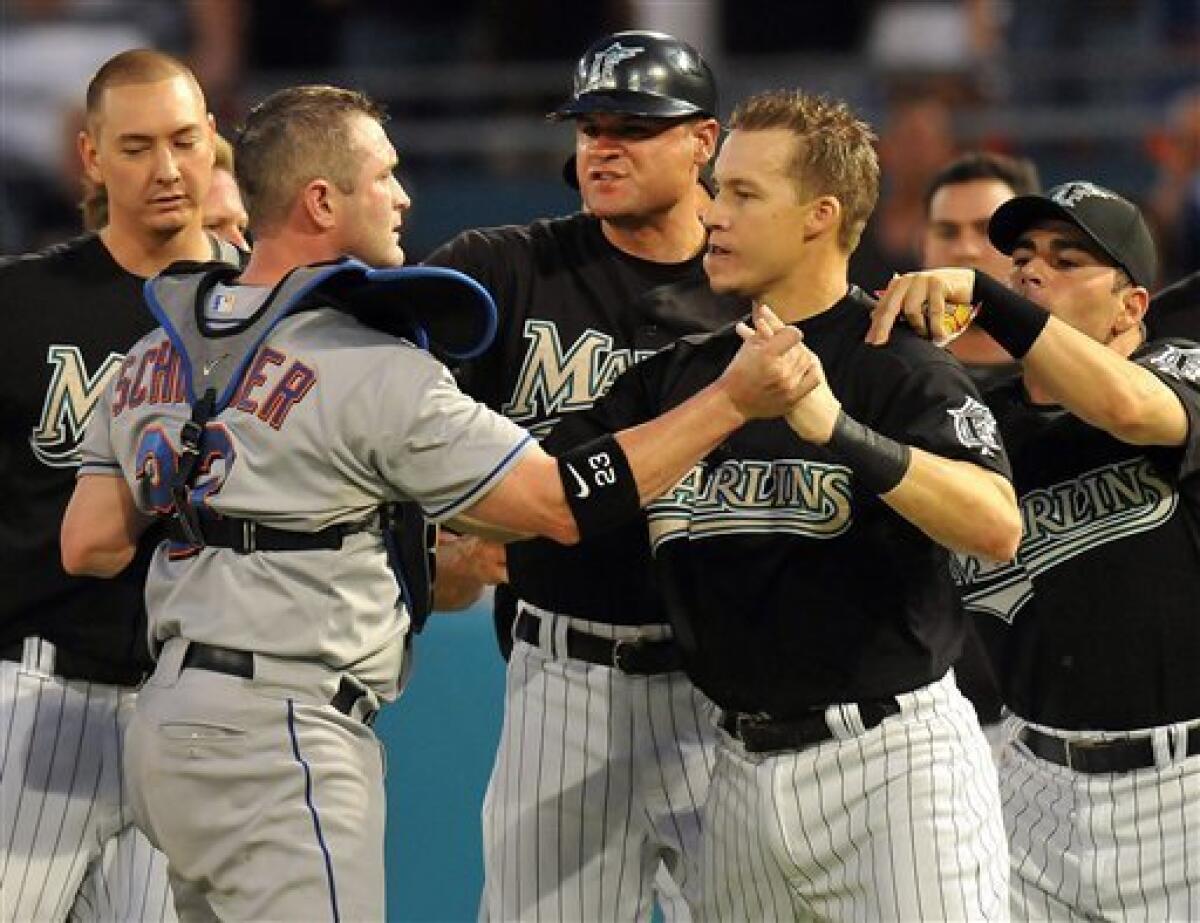 Florida Marlins' Jorge Cantu bumps arms with Dan Uggla, who hit a