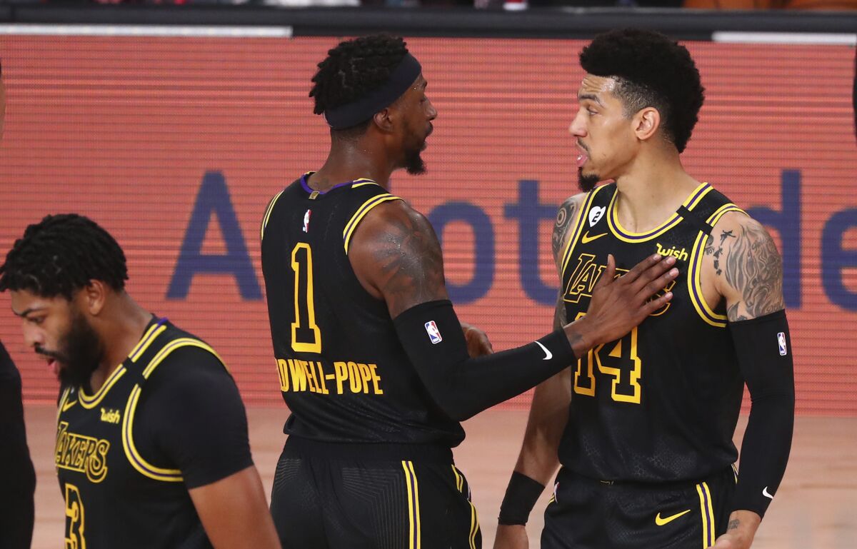 Lakers guards Danny Green, right, and Kentavious Caldwell-Pope talk during Game 4 against Portland on Aug. 24, 2020.