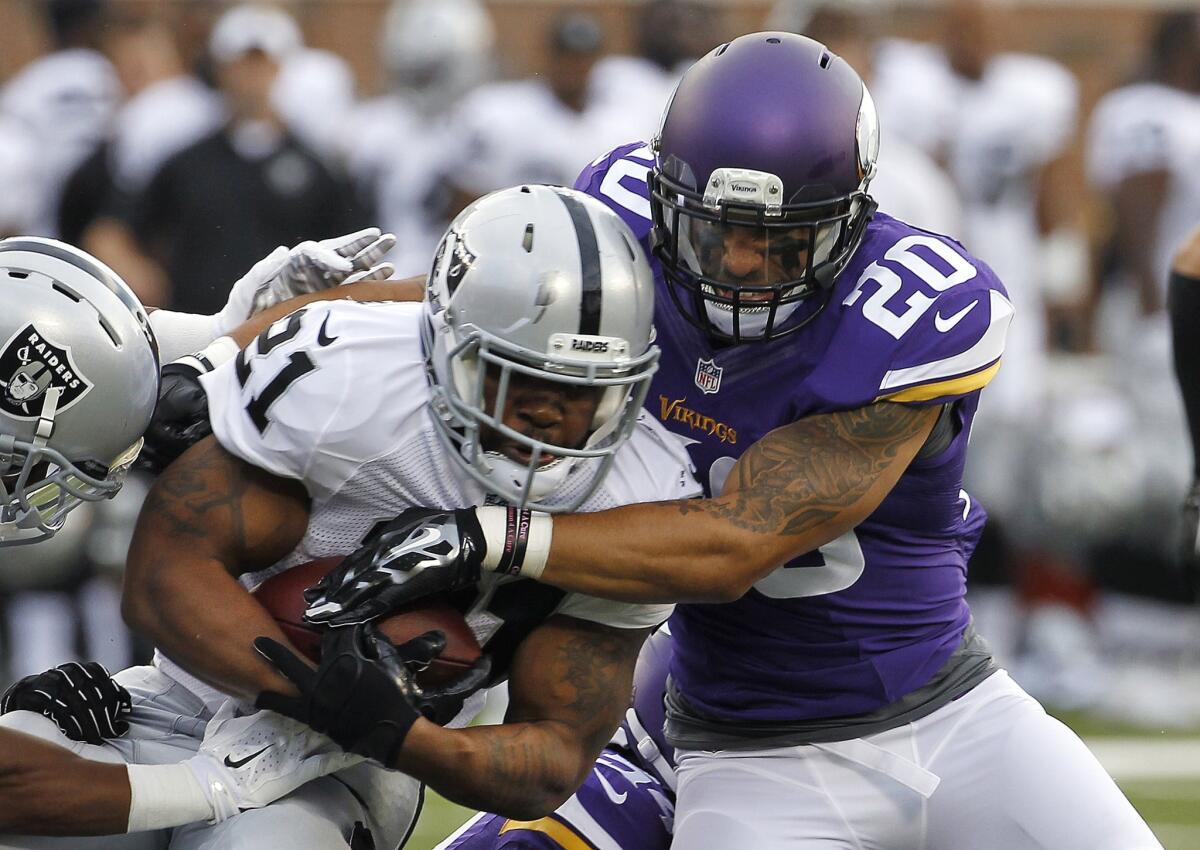 Oakland Raiders running back Maurice Jones-Drew is wrapped up by Minnesota Vikings safety Kurt Coleman during the first half of a preseason game on Friday at TCF Bank Stadium in Minneapolis. The Vikings defeated the Raiders, 10-6.