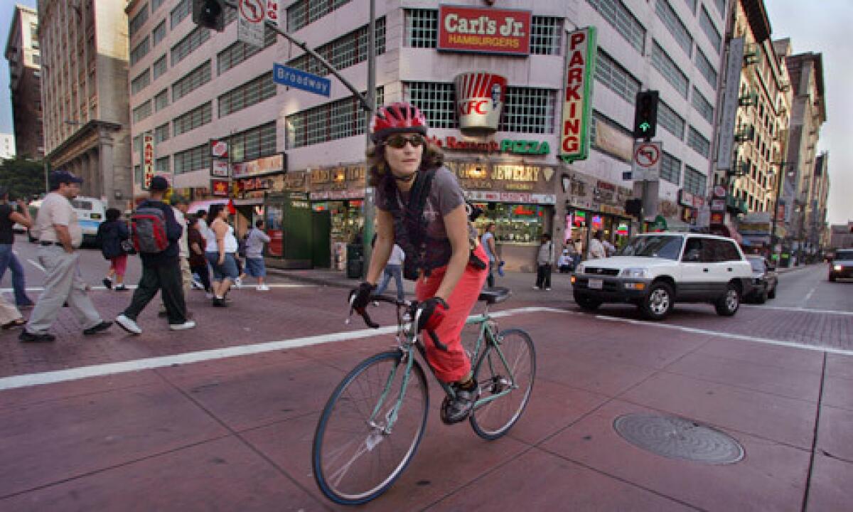 Artist Lisa Anne Auerbach weaves her way along Broadway in downtown Los Angeles.