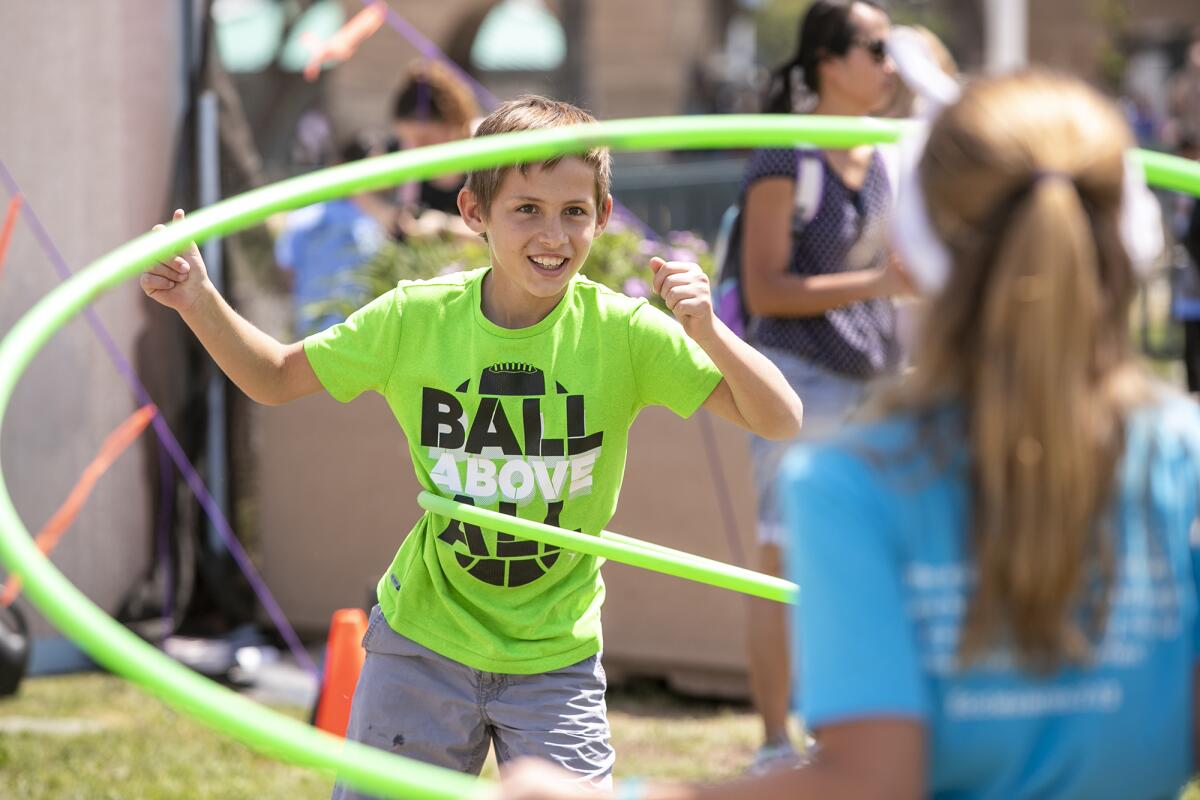 Andrew Harrison, 10, tests his skills with a hula hoop at Imaginology 2019 at the OC Fair & Event Center.