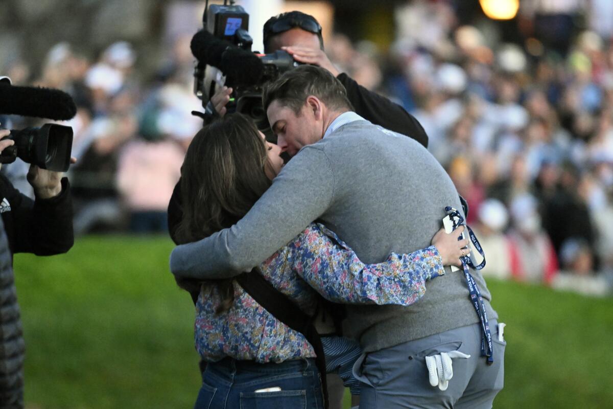 Luke List kisses his wife, Chloe, after winning the Farmers Insurance Open.