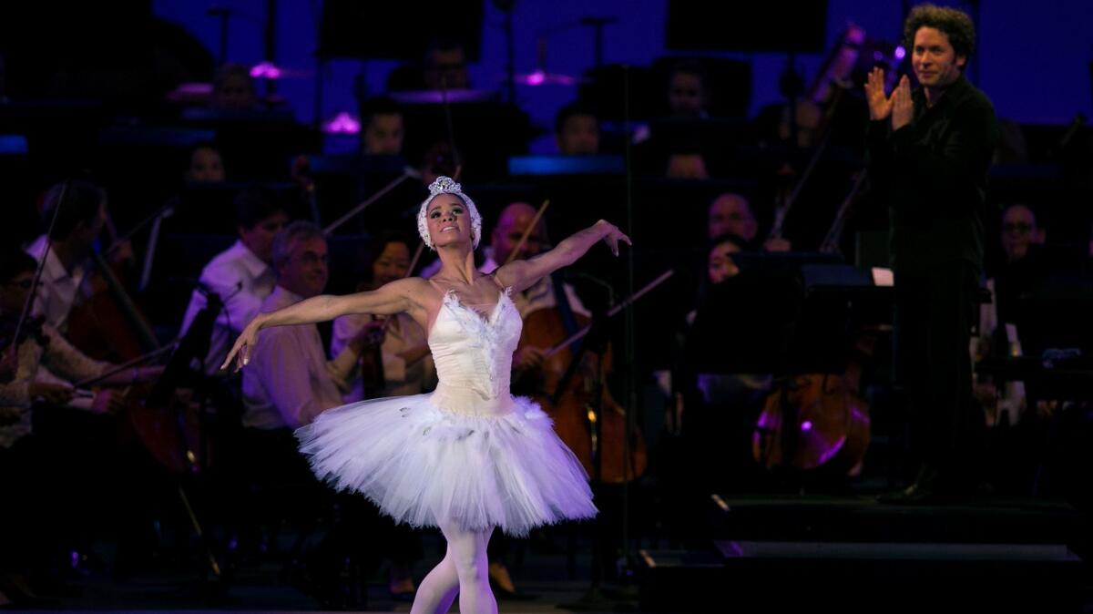 Misty Copeland is applauded by Gustavo Dudamel after performing a solo from Tchaikovsky's "Swan Lake" at the Hollywood Bowl.