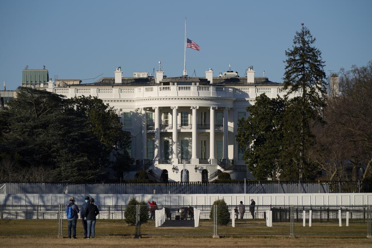 An American flag flies at half-staff above the White House on Sunday.