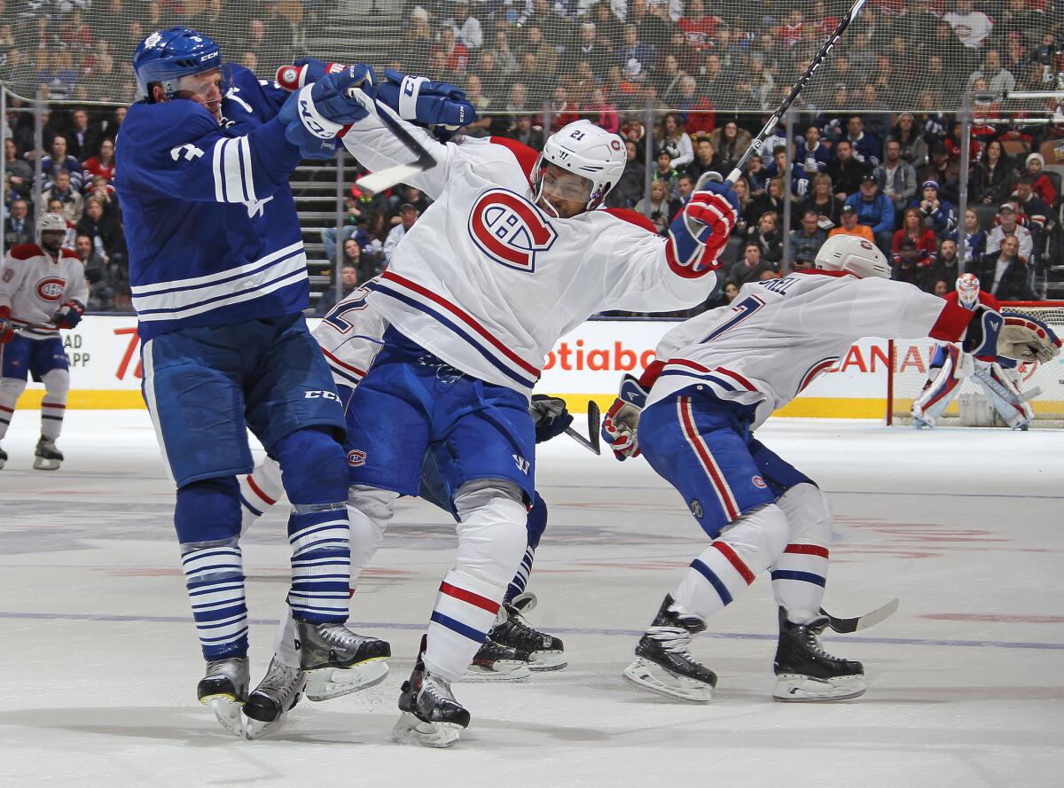 Canadiens forward Devante Pelly-Smith and Maple Leafs defenseman Dion Phaneuf collide during a game at the Air Canada Centre.