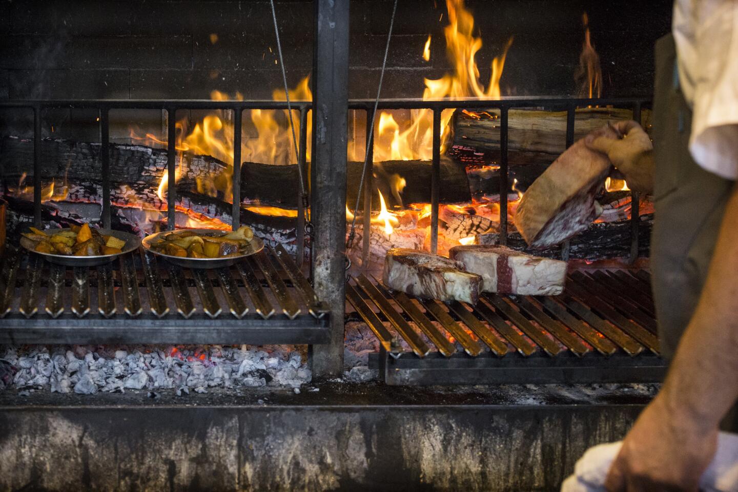 Vegetables and rib-eye steaks are cooked over the coals at Rossoblu.