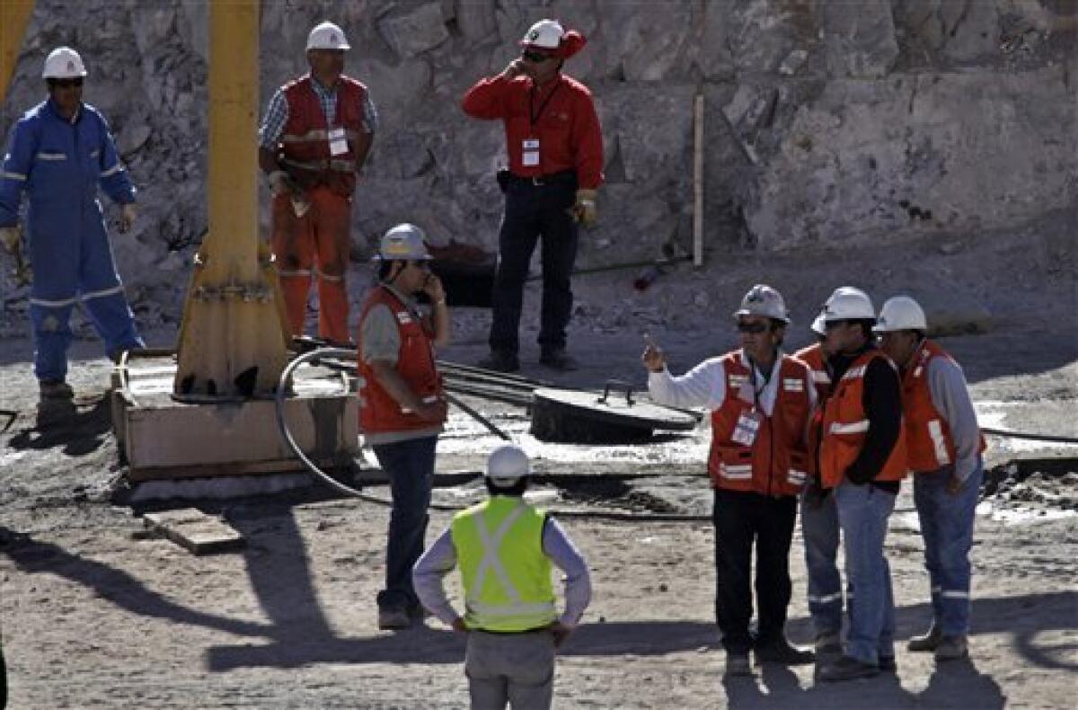 Rescue personnel works on the final arrangements at the site where the 33 trapped miners are going to come out on a capsule at the San Jose mine near Copiapo, Chile, Tuesday, Oct. 12, 2010. The first of 33 trapped miners is expected to be lifted to the surface late Tuesday after surviving more than two months below ground.(AP Photo/Jorge Saenz)