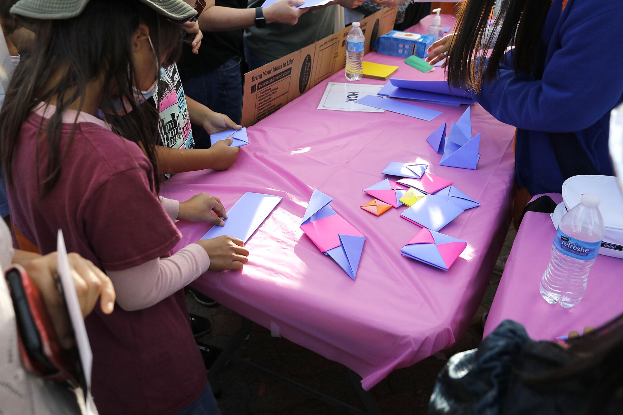 A booth at Korea Day showed the public how to create Ddakji, a traditional game.