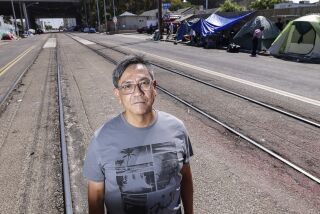 San Diego, CA - September 16: Writer Frank Ken Saragosa, who was formerly homeless, poses for photos near the intersection at 17th Street and Commercial Street on Friday, Sept. 16, 2022 in San Diego, CA. (Eduardo Contreras / The San Diego Union-Tribune)