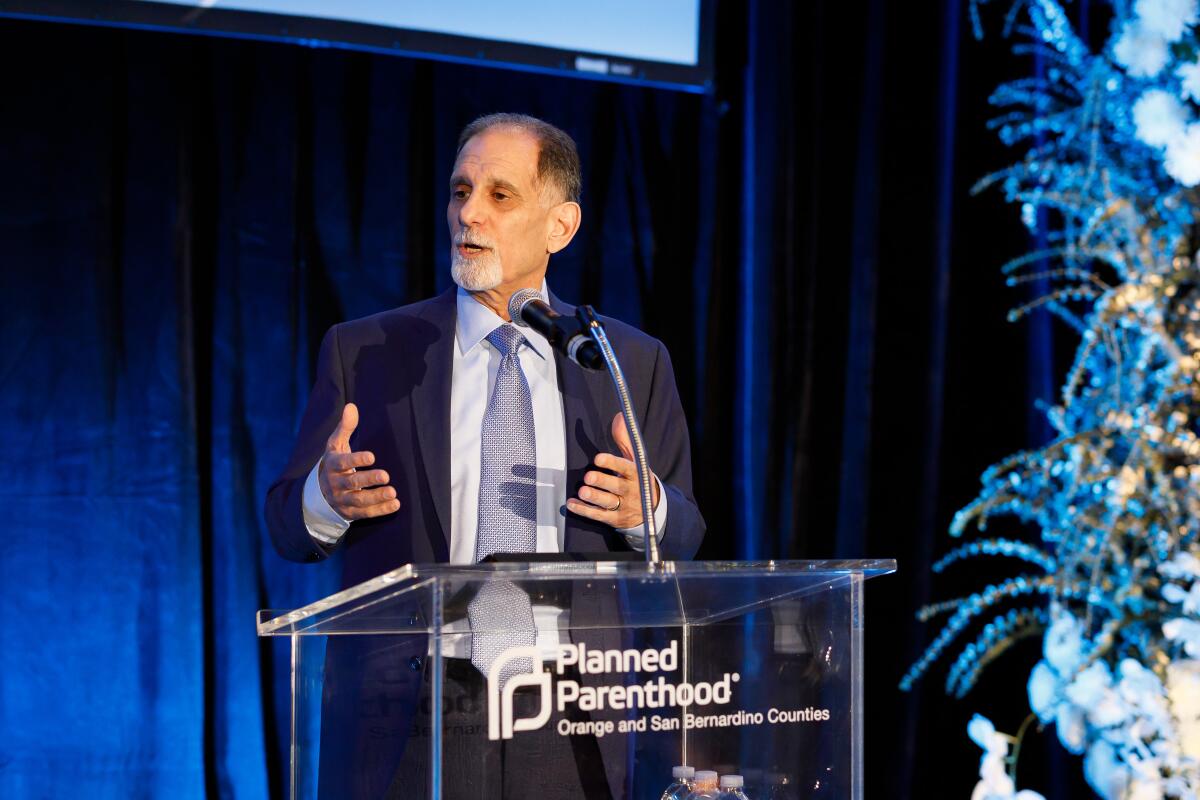 Jon Dunn speaks at a lectern with the Planned Parenthood logo.