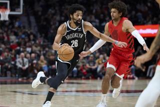 Brooklyn Nets guard Spencer Dinwiddie drives against Portland Trail Blazers guard Matisse Thybulle.