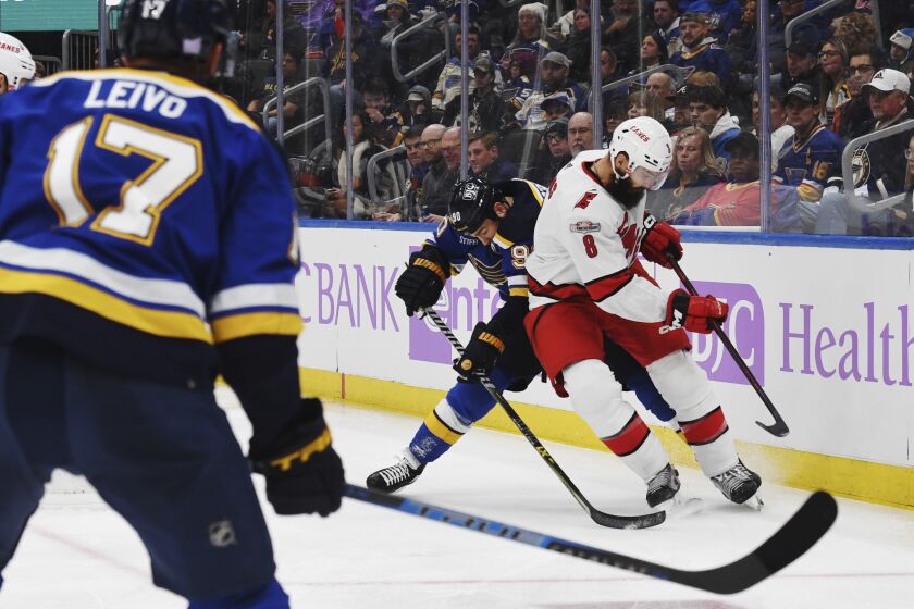 Carolina Hurricanes' Brent Burns (8) vies for the puck against St. Louis Blues' Ryan O'Reilly (90) during the second period of an NHL hockey game Thursday, Dec. 1, 2022, in St. Louis. (AP Photo/Michael Thomas)