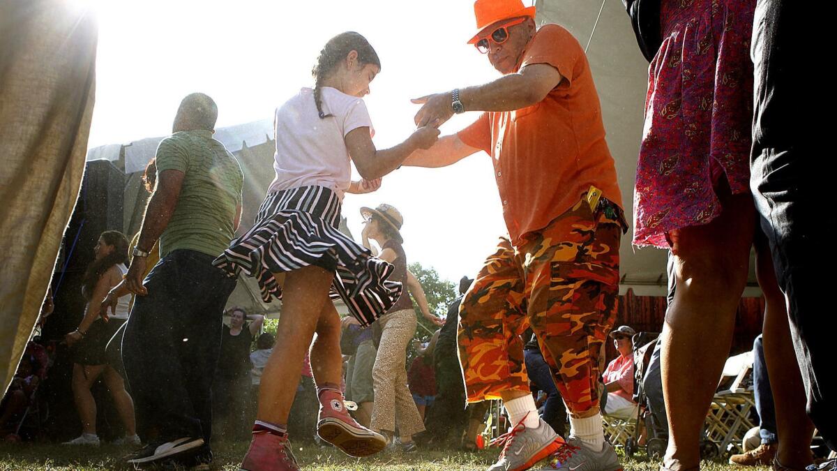 A father and daughter dance at the 2013 Lummis Days Festival.