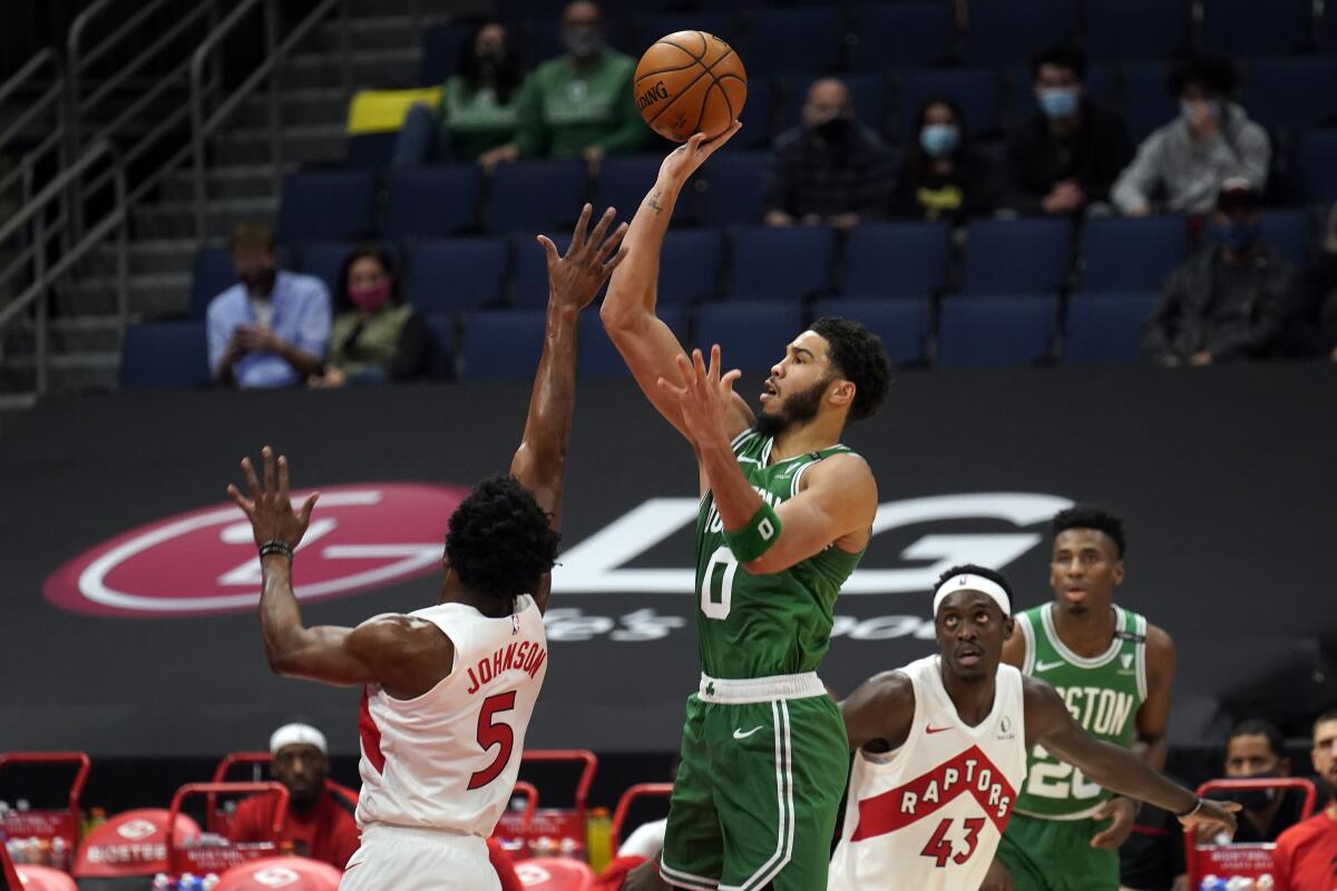 Boston Celtics forward Jayson Tatum shoots over Toronto Raptors forward Stanley Johnson.