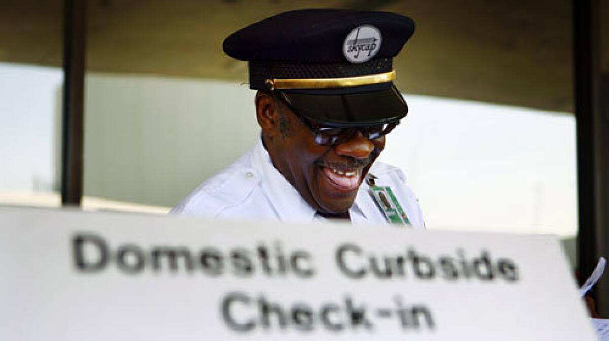 Henry Watts, 58, has been a skycap at Los Angeles International Airport for 20 years. An economic downturn in the airline industry has meant a cut in skycaps' earnings and work hours. More photos >>>