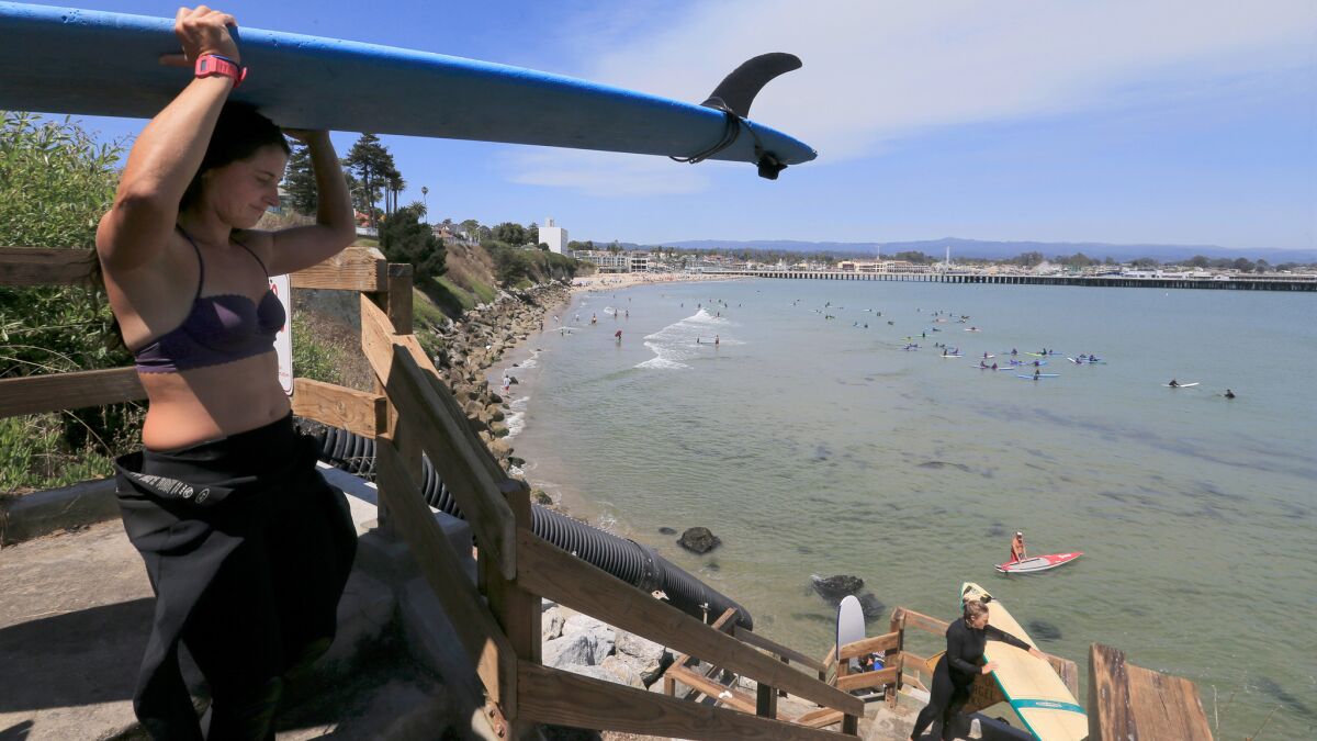Surfers head out to surf at Cowell's Beach in Santa Cruz.