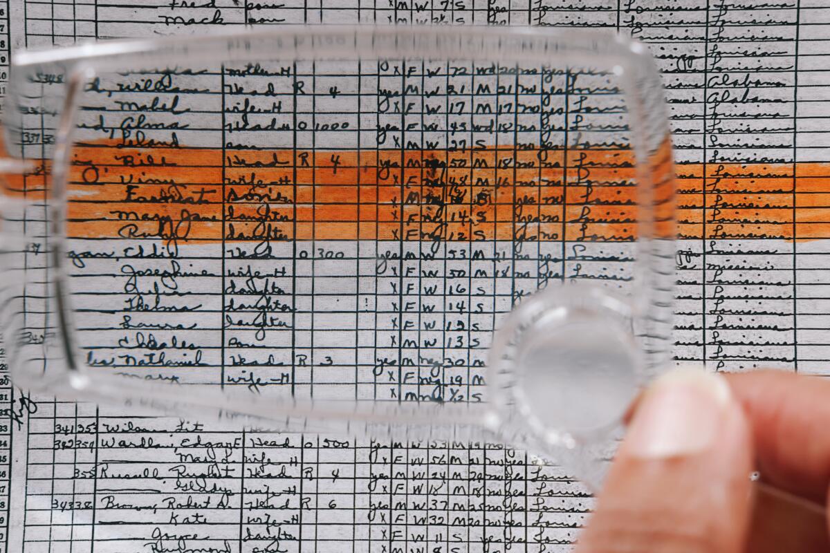  Pamela Clark uses a magnifying glass to see her aunt's name in the census.