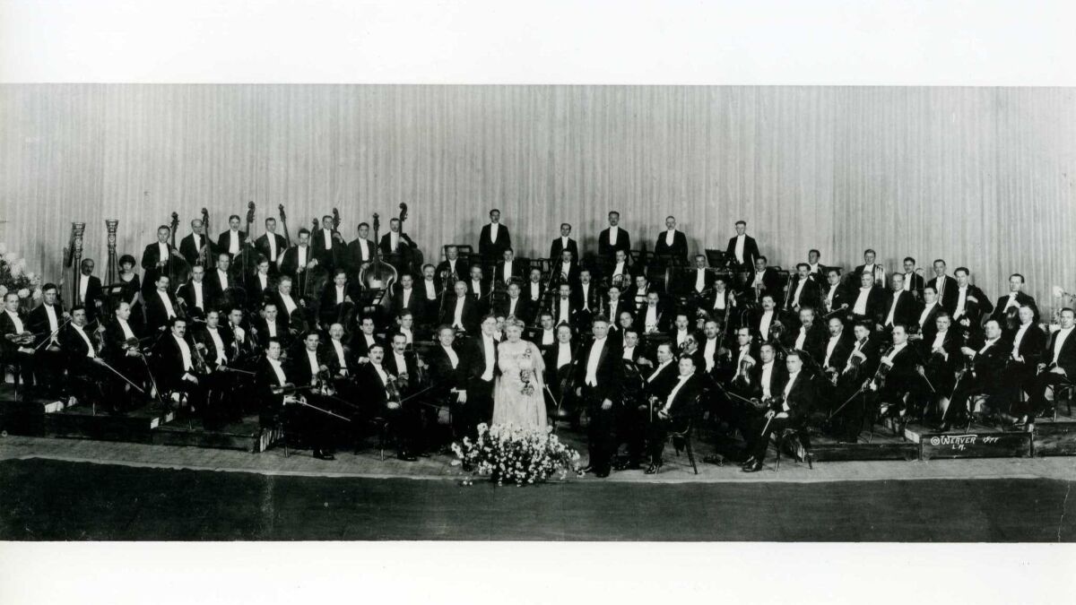 The newly formed Los Angeles Philharmonic, circa 1919. A century ago, founder W.A. Clark Jr. (standing with the first iteration of his orchestra above, center left) announced that the Los Angeles Philharmonic "shall grow to be the best in the United States."