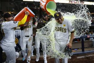 San Diego, CA - May 28: San Diego Padres players douse pitcher Jeremiah Estrada after a 4-0 win against the Miami Marlins at Petco Park on Monday, May 28, 2024 in San Diego, CA. Estrada struck out 13 batters in a row. (K.C. Alfred / The San Diego Union-Tribune)