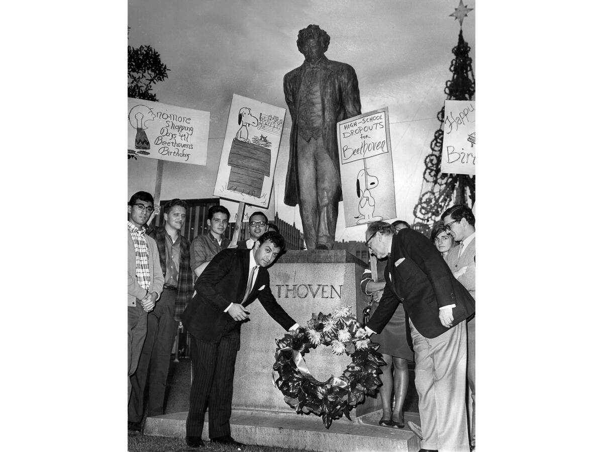 Dec. 16, 1966: Students with signs inspired by the comic strip "Peanuts" went to Pershing Square in observance of Beethoven's 196th birthday. Zubin Mehta, left, from the Los Angeles Philharmonic Orchestra, and Feri Roth of UCLA placed a wreath at the statue.