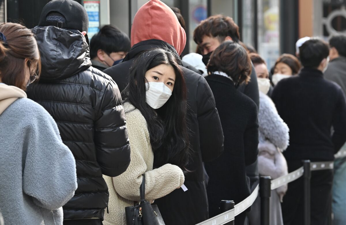 People wait in line to buy masks in Daegu, South Korea, in February.