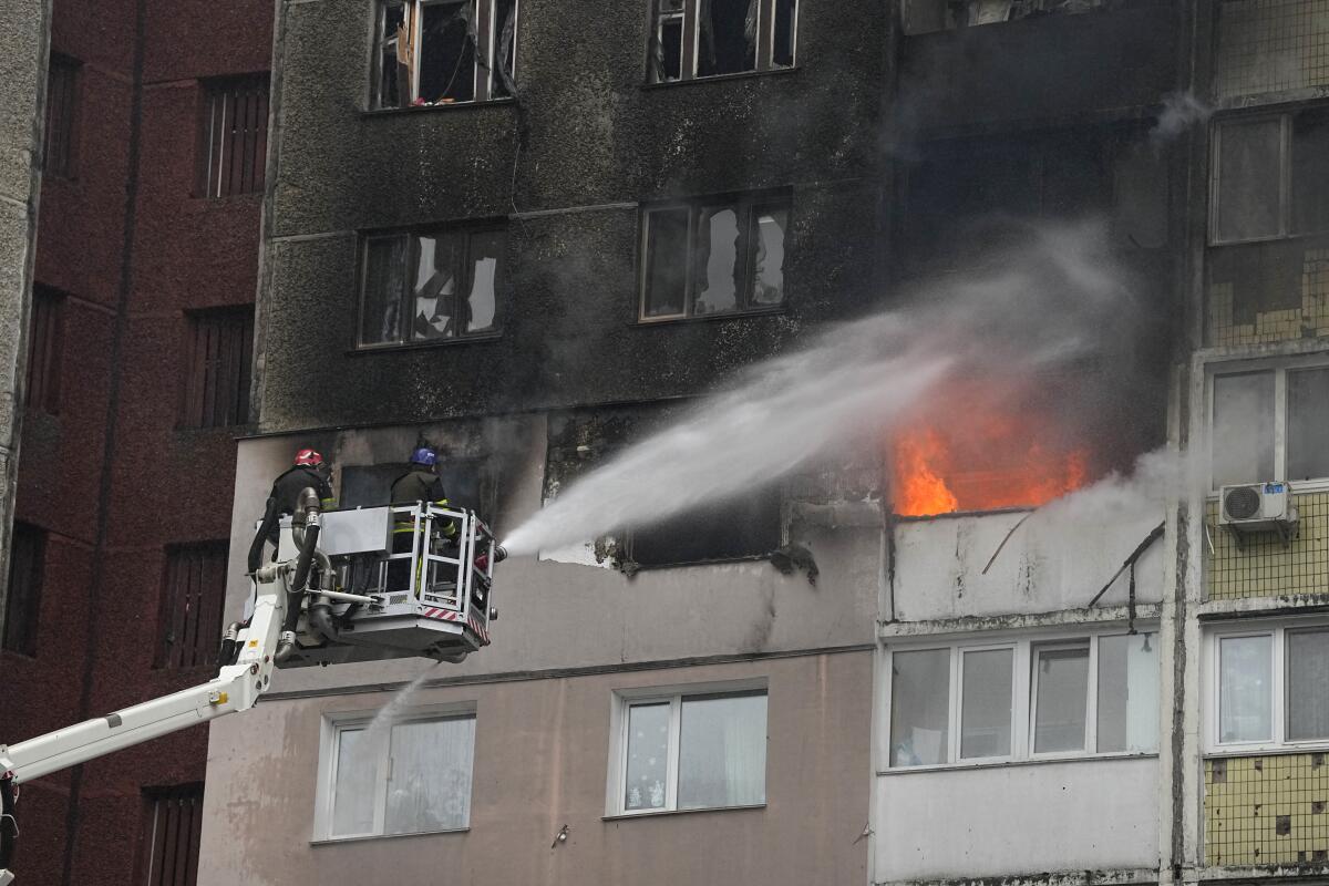 Firefighters work to extinguish a blaze in an apartment building
