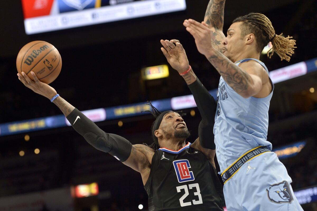 Clippers forward Robert Covington has his shot challenged by Grizzlies forward Brandon Clarke.