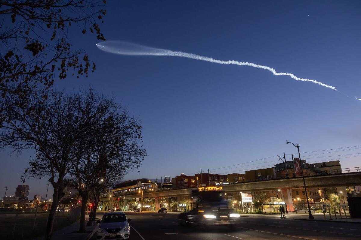 A SpaceX Falcon 9 rocket is seen from Chinatown in Los Angeles in March 2024. 