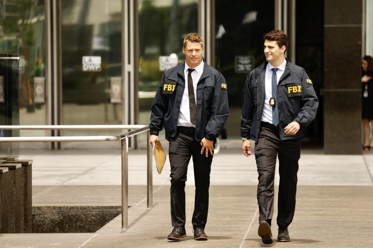 FBI agents leave the downtown headquarters of the Los Angeles Department of Water and Power.