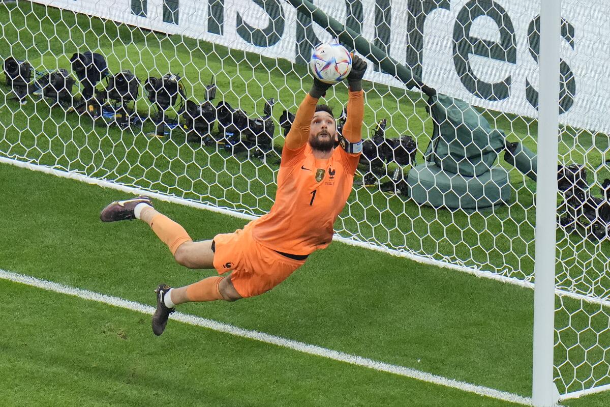 France goalkeeper Hugo Lloris makes leaping save during a World Cup quarterfinal match against England in December 2022.