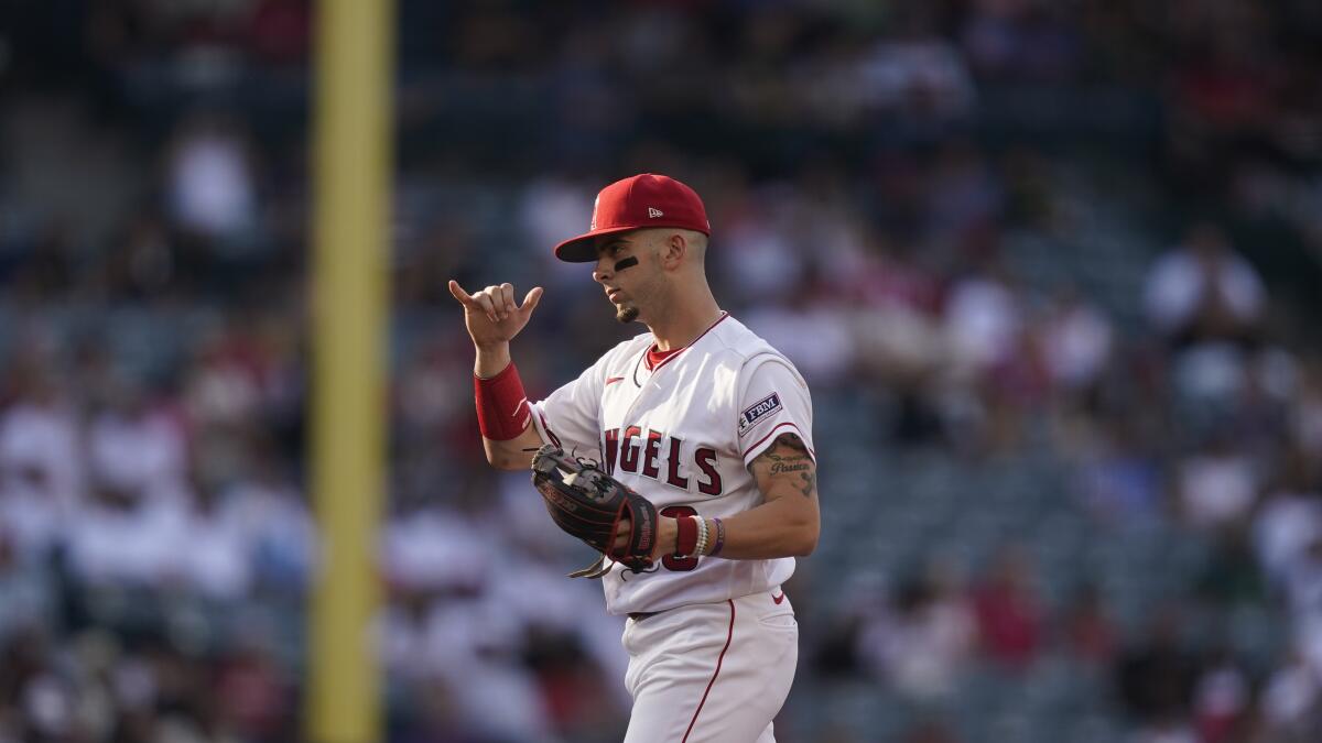 Zach Neto signals during an Angels game.