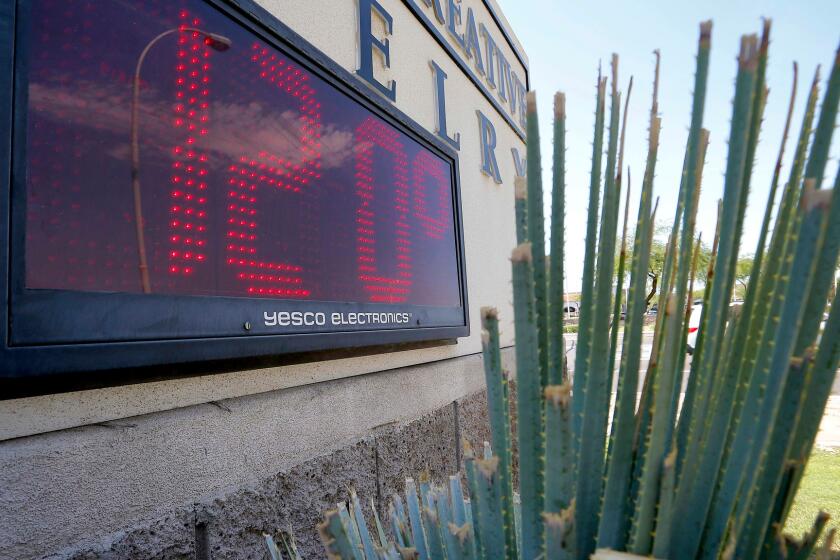 Sign indicates the temperature in Phoenix on a June day.