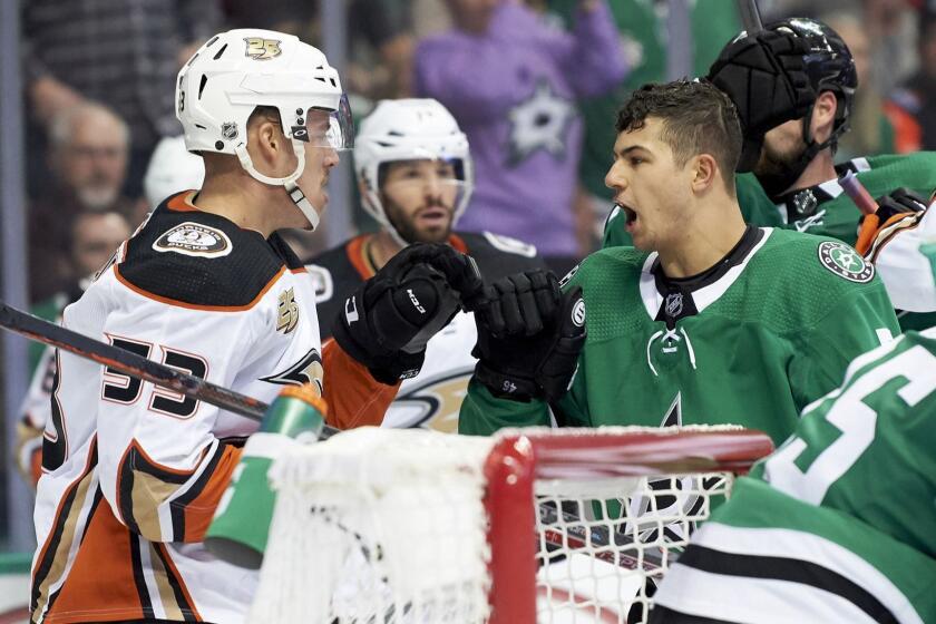 Dallas Stars defenseman Connor Carrick (5) has words with Anaheim Ducks left wing Max Comtois (53) during the second period of an NHL hockey game Saturday, Oct. 13, 2018, in Dallas. (AP Photo/Cooper Neill)
